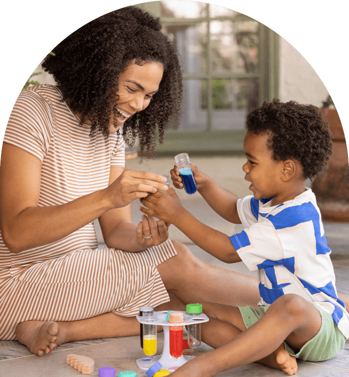 Mother and son playing with the Liquid Color Lab from The Problem Solver Play Kit