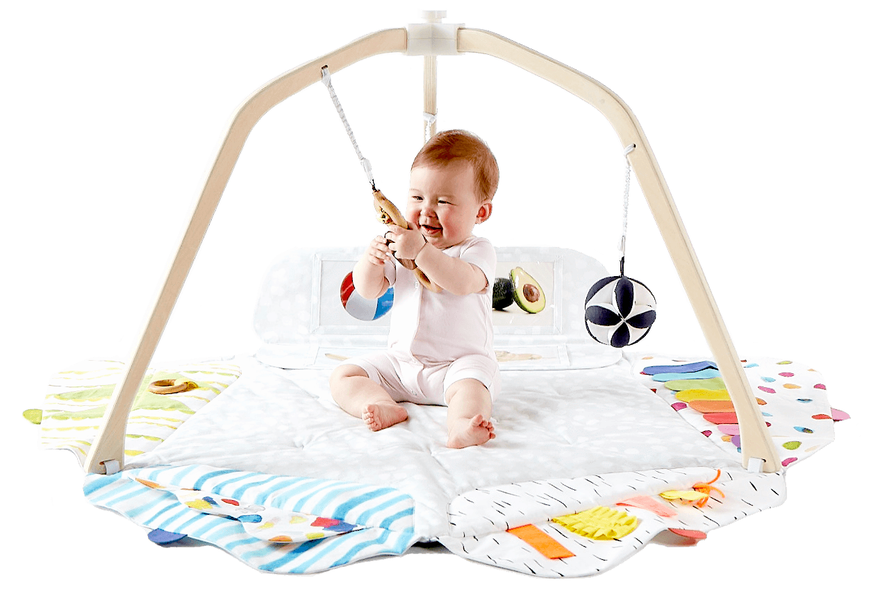 Baby playing with the High-Contrast Ball and the Batting Ring from The Play Gym by Lovevery