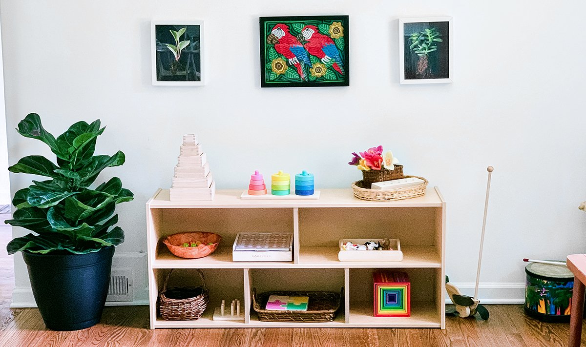 A wooden shelf filled with toys by Lovevery